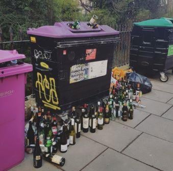 Overflowing glass waste bins